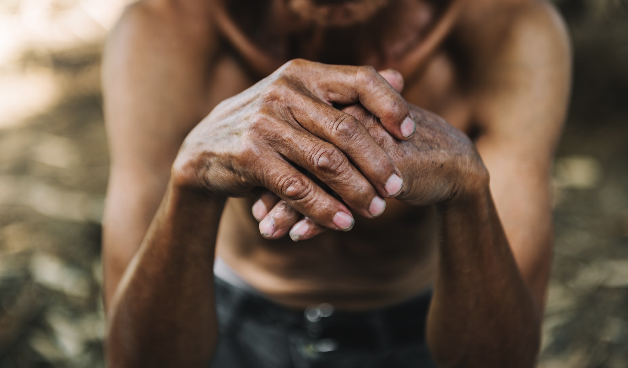 Close up of male wrinkled hands, old man is wearing